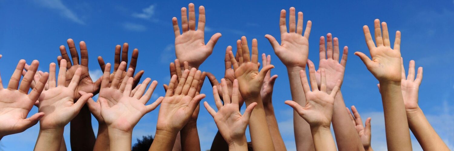 Raised hands showing volunteering